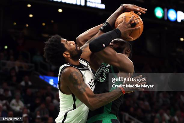 Kyrie Irving of the Brooklyn Nets defends a shot from Jaylen Brown of the Boston Celtics during the fourth quarter of Round 1 Game 1 of the 2022 NBA...