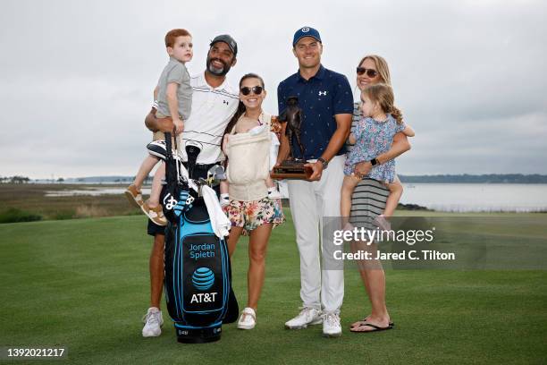 Jordan Spieth and caddie Michael Greller pose with the trophy with their families after winning the RBC Heritage in a playoff at Harbor Town Golf...