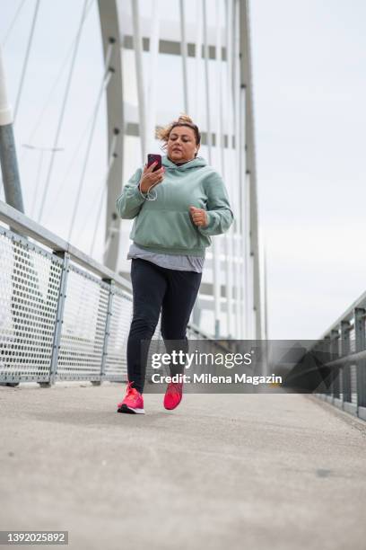 portrait of an obese hispanic latin  woman struggling with weight loss running - fat loss training stock pictures, royalty-free photos & images