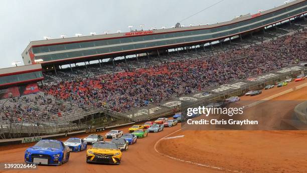 Cole Custer, driver of the Jacob Construction/HaasTooling Ford, and Christopher Bell, driver of the DeWalt Toyota, lead the field on a pace lap prior...