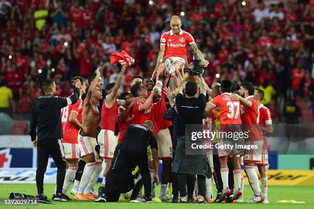 Andrés D'Alessandro of Internacional celebrates with teammates during his retirement ceremony after a match between Internacional and Fortaleza as...