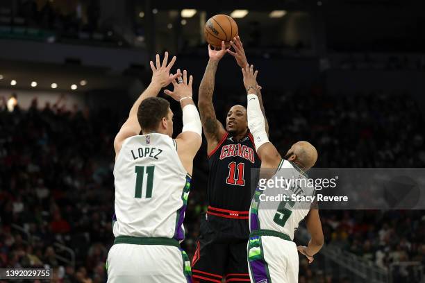 DeMar DeRozan of the Chicago Bulls shoots over Brook Lopez and Jevon Carter of the Milwaukee Bucks during the second quarter of Game One of the...