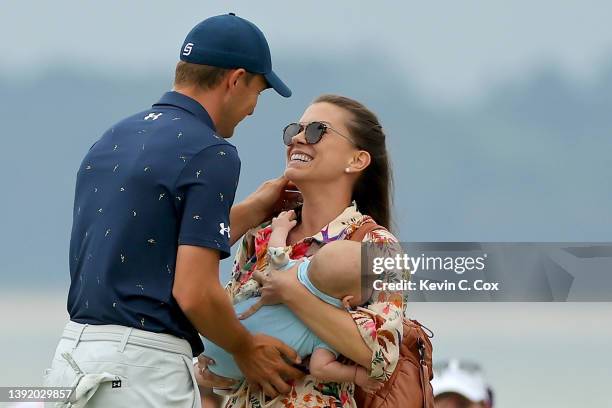 Jordan Spieth and wife Annie Verret celebrate with son Sammy on the 18th green after Spieth beat Patrick Cantlay in a playoff to win the RBC Heritage...