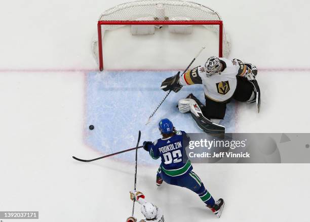 Vasily Podkolzin of the Vancouver Canucks takes a shot on Robin Lehner of the Vegas Golden Knights during their NHL game at Rogers Arena April 12,...