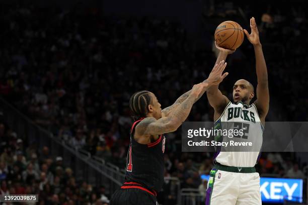 Khris Middleton of the Milwaukee Bucks shoots over DeMar DeRozan of the Chicago Bulls during the second half of Game One of the Eastern Conference...