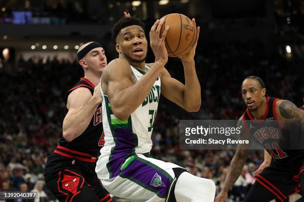 Giannis Antetokounmpo of the Milwaukee Bucks works against Alex Caruso of the Chicago Bulls during the second half of Game One of the Eastern...
