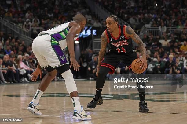 DeMar DeRozan of the Chicago Bulls is defended by Khris Middleton of the Milwaukee Bucks during the second quarter of Game One of the Eastern...