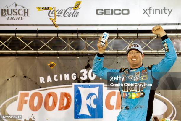 Kyle Busch, driver of the Mars Crunchy Cookie Toyota, celebrates in victory lane after winning the NASCAR Cup Series Food City Dirt Race at Bristol...