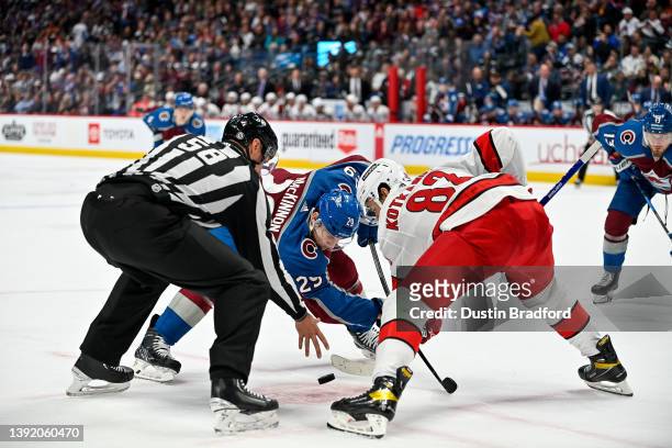 Nathan MacKinnon of the Colorado Avalanche takes a face off against Jesperi Kotkaniemi of the Carolina Hurricanes in the second period of a game at...