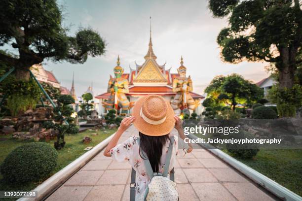 adventure asian beautiful tourist women travel in the buddha temple back view in bangkok thailand - bangkok ストックフォトと画像