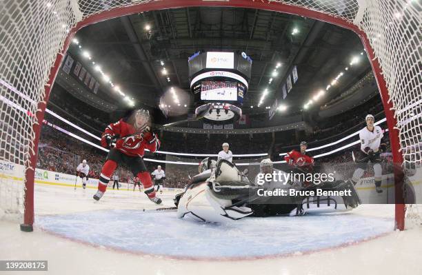 Zach Parise of the New Jersey Devils watches a shot by Adam Henrique elude goaltender Jonas Hiller of the Anaheim Ducks at 1:25 of the second period...