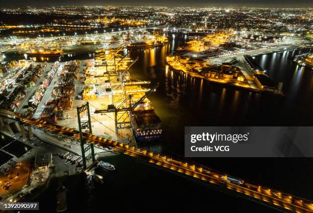 An aerial view of shipping containers sitting stacked at the Port of Los Angeles at night on April 15, 2022 in San Pedro, California.
