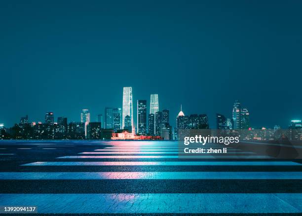 empty city street at night - city lights reflected on buildings speed stock pictures, royalty-free photos & images