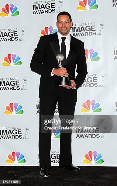 Actor Laz Alonzo poses with the award for Outstanding Actor in a Motion Picture for 'Jumping the Broom' in the press room at the 43rd NAACP Image...