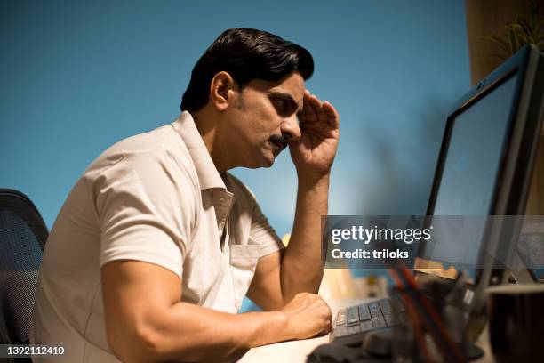 man using computer at home - indian man computer screen stock pictures, royalty-free photos & images