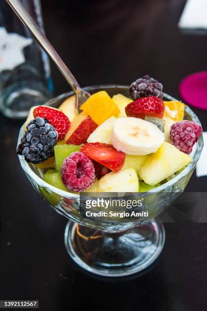 fruit salad in glass bowl - fruit salad stock pictures, royalty-free photos & images