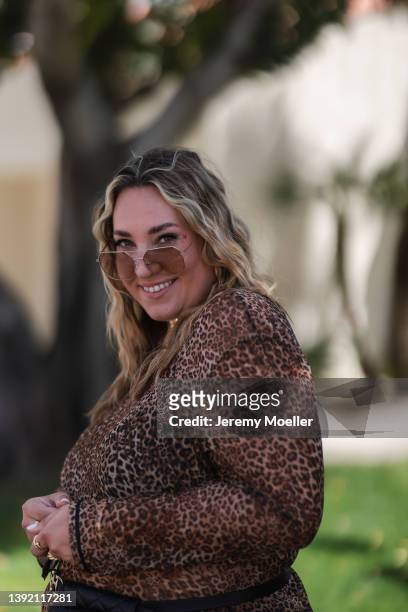 Verena Prechtl seen wearing a brown sunglasses, a gold statement necklace, a brown transparent leo print maxi dress on April 16, 2022 in Indio,...