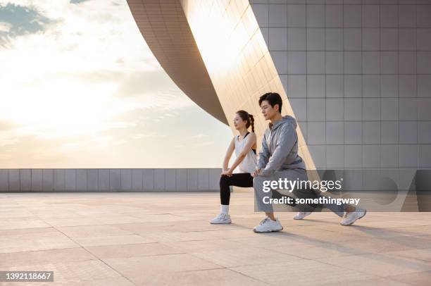 young asian couples exercise outdoors - asian couple exercise stock pictures, royalty-free photos & images