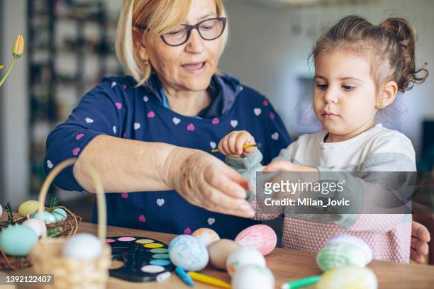 painting easter eggs - baby paint stock-fotos und bilder