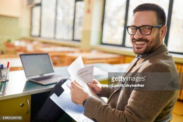 happy male teacher working in the classroom. - teacher stock pictures, royalty-free photos & images