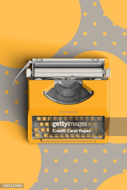 top view of a typewriter from the 70s with in grey and yellow polka dots background - table font view stock pictures, royalty-free photos & images