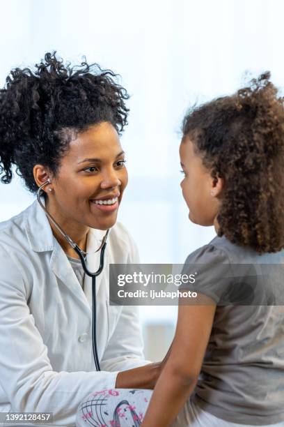 pediatrician with stethoscope listening to lung and heart sound of child - cardiologist bildbanksfoton och bilder