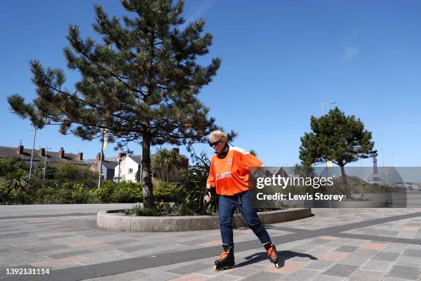 Fan of Blackpool is seen rollerskating outside the stadium to raise money for charity prior to the Sky Bet Championship match between Blackpool and...