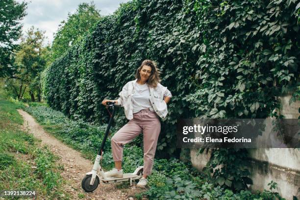 young woman with electric scooter. - step well stockfoto's en -beelden