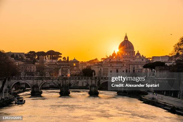 rome skyline with tiber river and st. peter's basilica at sunset, lazio, italy - river tiber stock pictures, royalty-free photos & images