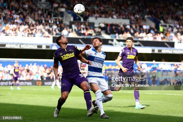 Curtis Davies of Derby County is marked by Luke Amos of Queens Park Rangers during the Sky Bet Championship match between Queens Park Rangers and...