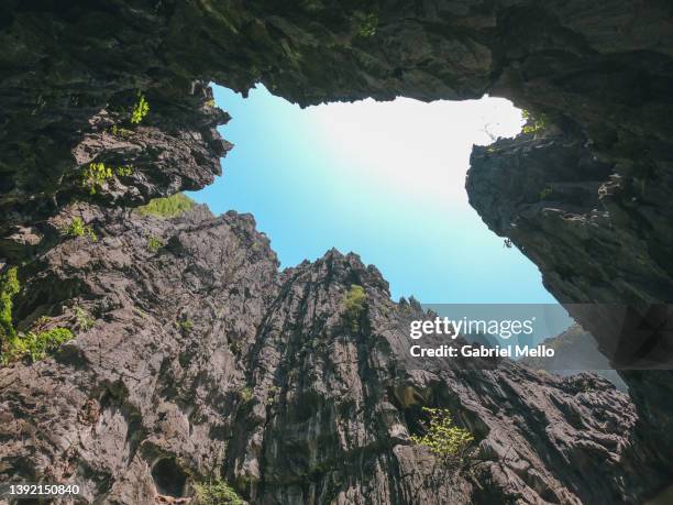 massive rock formations from a low angle perspective - el nido stock pictures, royalty-free photos & images