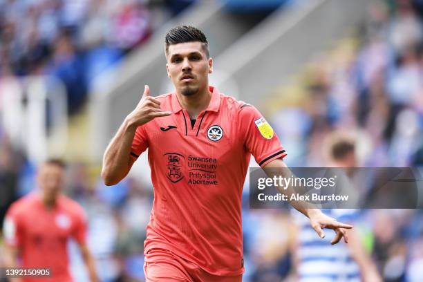 Joel Piroe of Swansea City celebrates scoring their side's third goal after scoring a penalty during the Sky Bet Championship match between Reading...