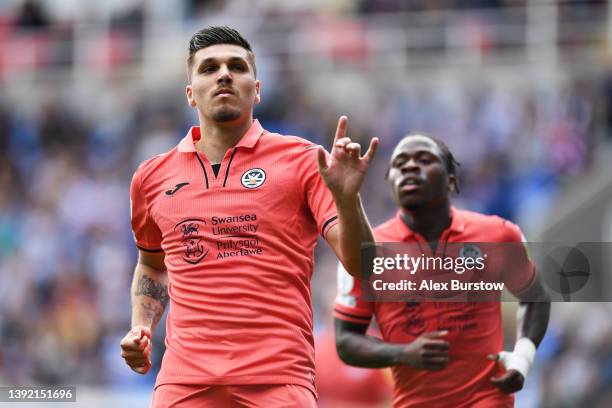 Joel Piroe of Swansea City celebrates scoring their side's third goal after scoring a penalty during the Sky Bet Championship match between Reading...