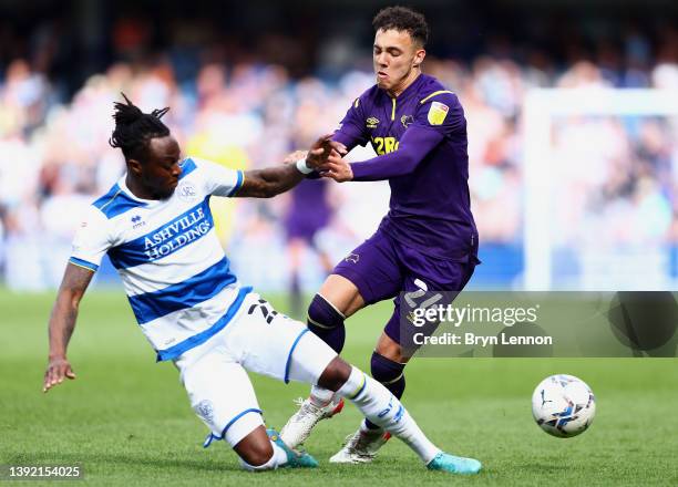 Moses Odubajo of Queens Park Rangers challenges Lee Buchanan of Derby County during the Sky Bet Championship match between Queens Park Rangers and...