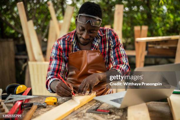carpenter using laptop in workshop - computer repair background stock pictures, royalty-free photos & images