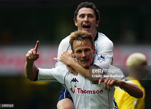 Teddy Sheringham of Tottenham Hotspur celebrates scoring their second goal with new team mate Robbie Keane during the FA Barclaycard Premiership...