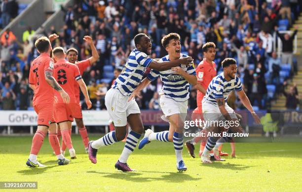 Tom McIntyre of Reading celebrates with teammate Yakou Meite after scoring their team's fourth goal during the Sky Bet Championship match between...