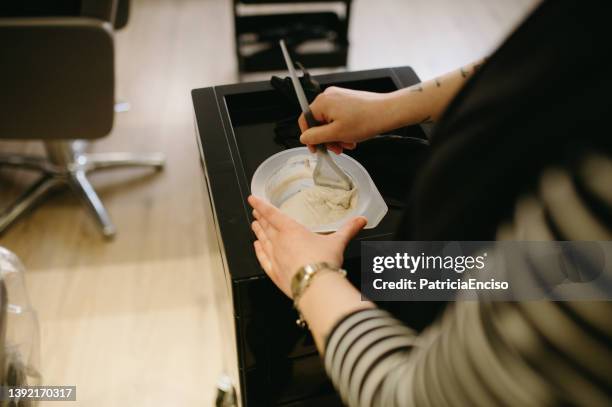 hairdresser mixing dye - hair coloring stock pictures, royalty-free photos & images