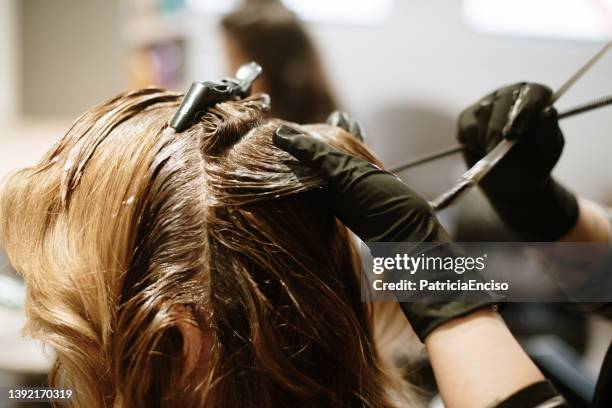 hairdresser dying a woman's hair - hair coloring stock pictures, royalty-free photos & images