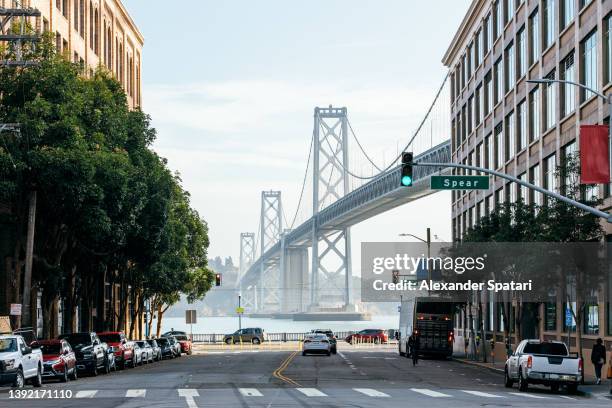 the san francisco - oakland bay bridge and street in san francisco, california, usa - san francisco bridge fotografías e imágenes de stock