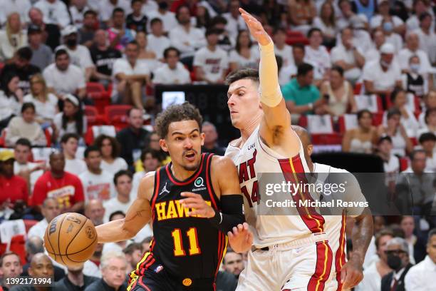 Trae Young of the Atlanta Hawks drives to the basket against Tyler Herro of the Miami Heat during the first half in Game One of the Eastern...