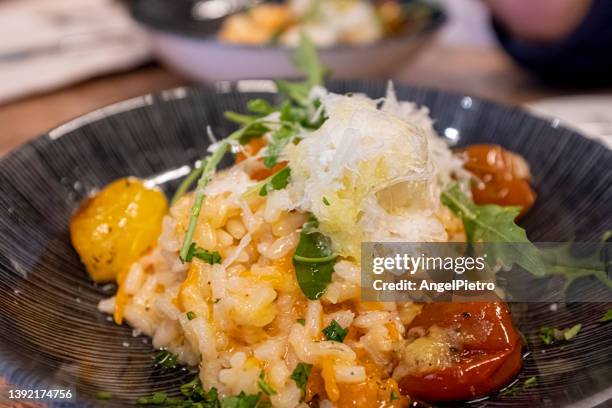 risotto with pumpkin, arugula and parmesan - risoto foto e immagini stock