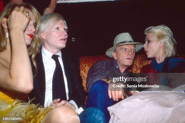 View of, from left, American model Jerry Hall, Pop artist Andy Warhol , author Truman Capote , and New Wave singer Debbie Harry as they attend an...