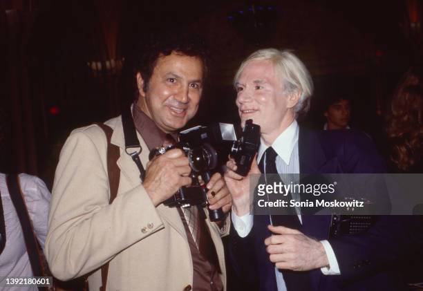 Portrait of American photographer Ron Galella and Pop artist Andy Warhol as they attend an unspecified event, New York, New York, August 12, 1978.