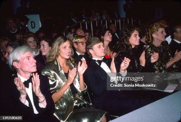 View of, front row from left, Pop artist Andy Warhol , actress & model Lauren Hutton, dancer Mikhail Baryshnikov, actress Brooke Shields, and...