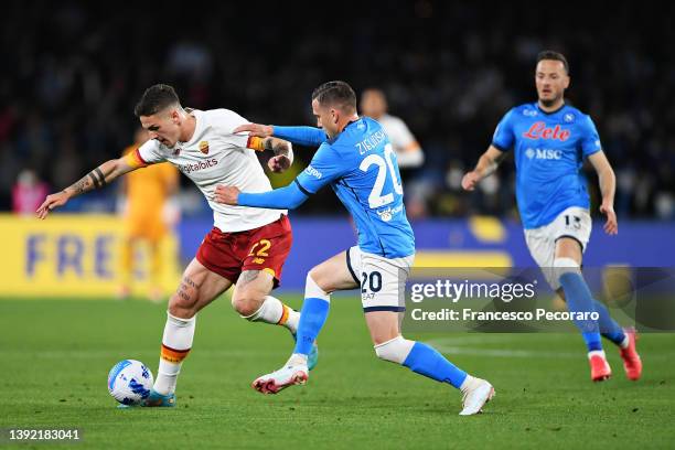 Nicolo Zaniolo of AS Roma is challenged by Piotr Zielinski of Napoli during the Serie A match between SSC Napoli and AS Roma at Stadio Diego Armando...