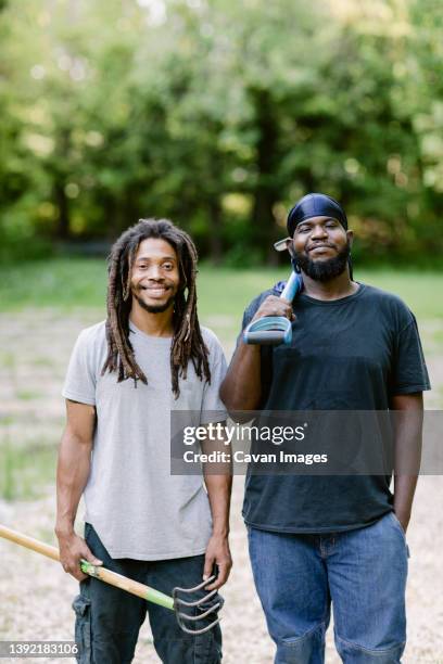 two black farmers smiling at the camera while holding farm tools - bridgeport connecticut fotografías e imágenes de stock