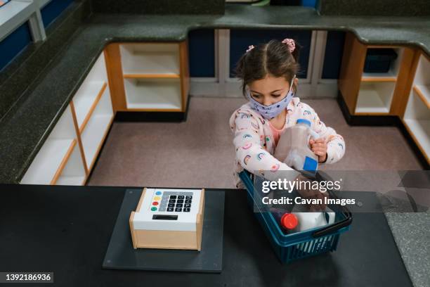 girl playing with toy cash register - supermarket register stock-fotos und bilder