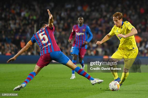 Sergio Busquets of Barcelona challenges Alex Fernandez of Cadiz during the LaLiga Santander match between FC Barcelona and Cadiz CF at Camp Nou on...