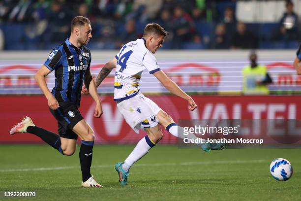 Ivan Ilic of Hellas Verona shoots goalwards, his effort was subsequently parried by Juan Musso of Atalanta only for it to deflect off the chest of...